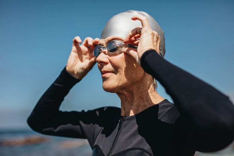 putting on swim goggles